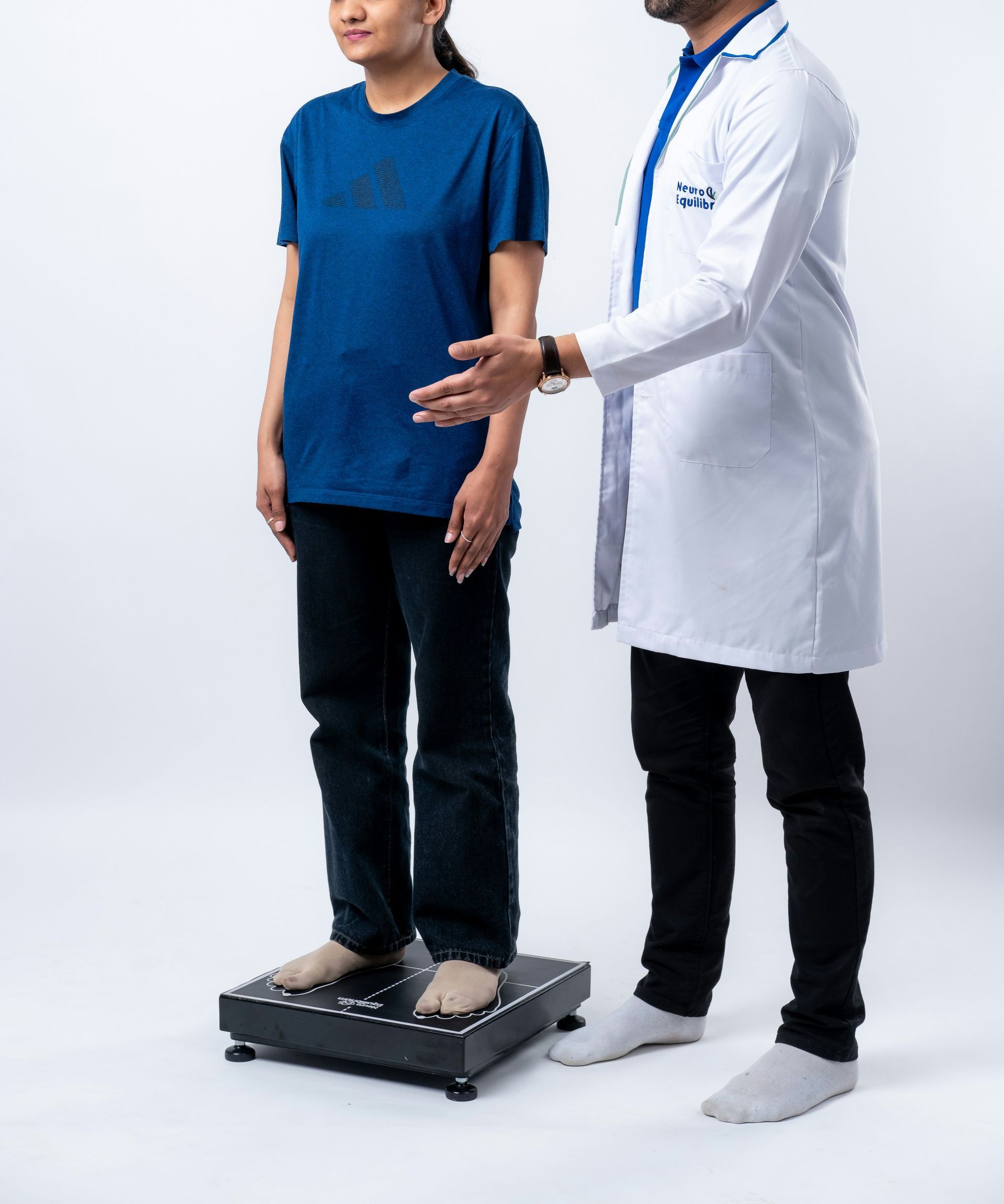 Doctor weighing a young woman on a scale